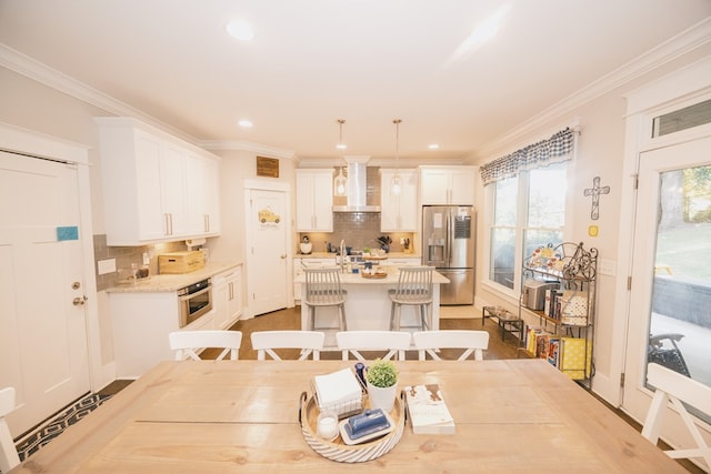 dining room with plenty of natural light and crown molding