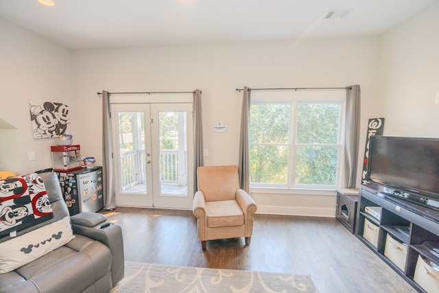 living room with dark hardwood / wood-style flooring and french doors