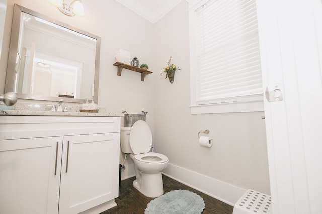 bathroom with crown molding, hardwood / wood-style floors, vanity, and toilet