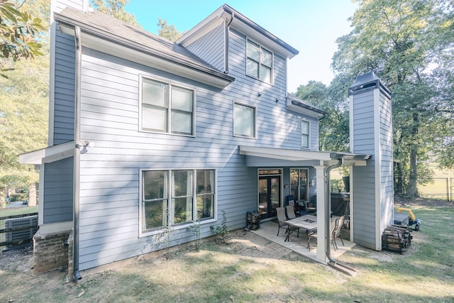 rear view of house with a patio area and a yard