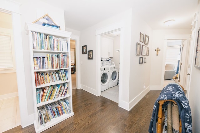 corridor featuring dark wood-type flooring and washing machine and clothes dryer