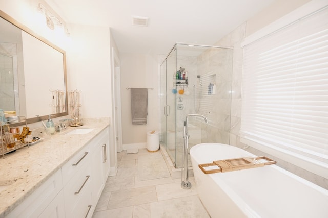 bathroom featuring vanity and independent shower and bath