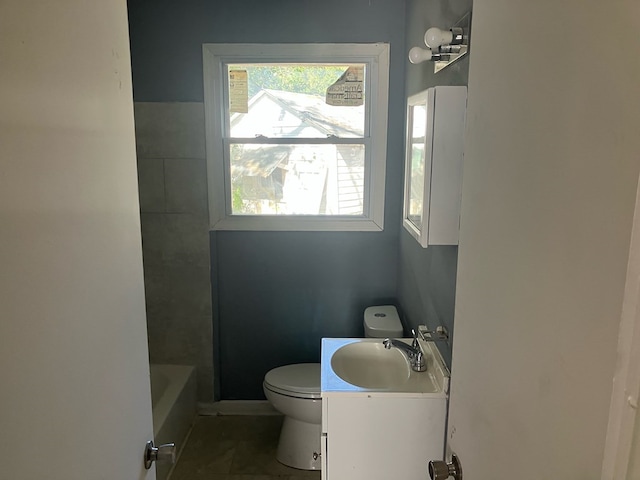 bathroom featuring a bathing tub, vanity, and toilet