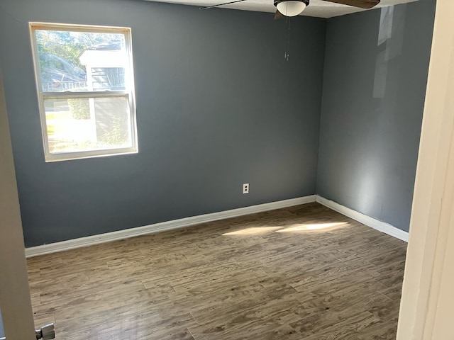 empty room with ceiling fan and hardwood / wood-style flooring