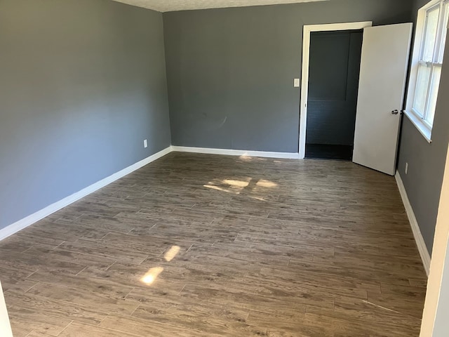 unfurnished room featuring hardwood / wood-style floors and a textured ceiling