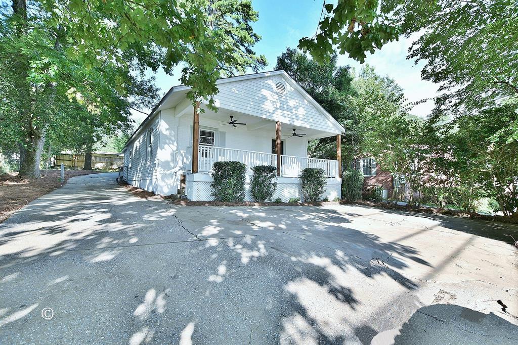 view of property exterior featuring a porch and ceiling fan