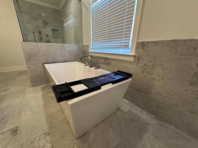 906 NE Winall Down Rd, Atlanta, GA 30319 - full bathroom with walk in shower, tile walls, a freestanding tub, and ornamental molding