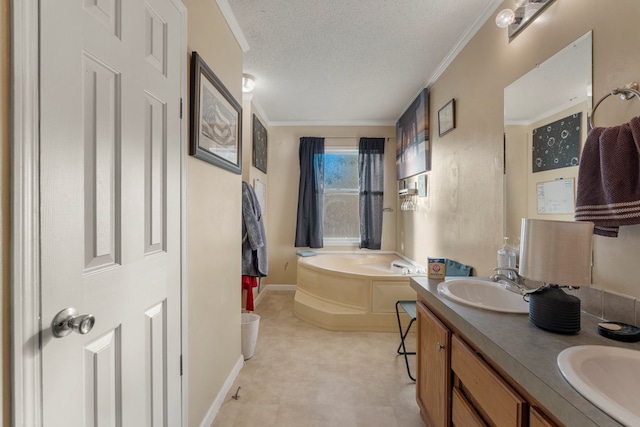 bathroom featuring a washtub, vanity, a textured ceiling, and ornamental molding