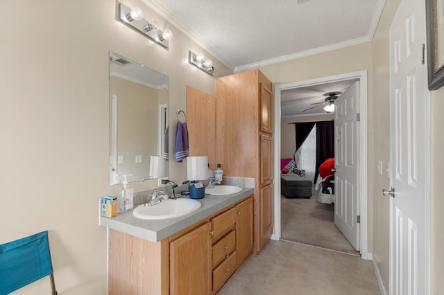 bathroom featuring vanity, a textured ceiling, ceiling fan, and ornamental molding