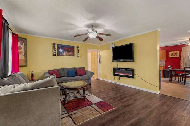 living room with crown molding, ceiling fan, dark wood-type flooring, and a textured ceiling