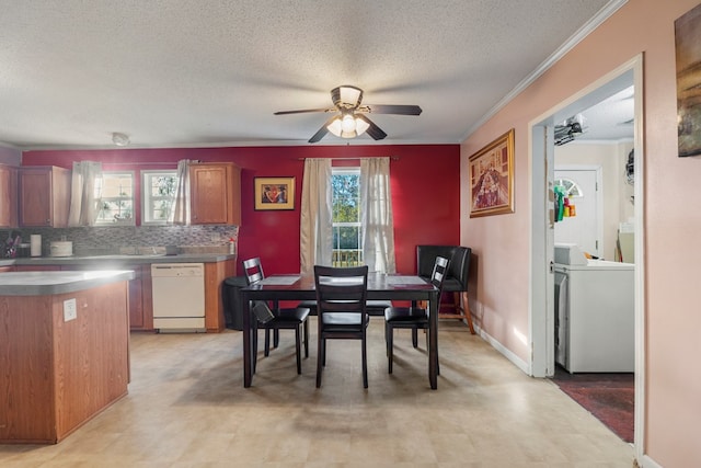 dining space featuring ceiling fan, ornamental molding, a textured ceiling, and washer / clothes dryer