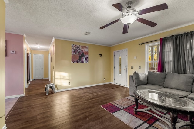 living room with a textured ceiling, dark hardwood / wood-style floors, ceiling fan, and crown molding