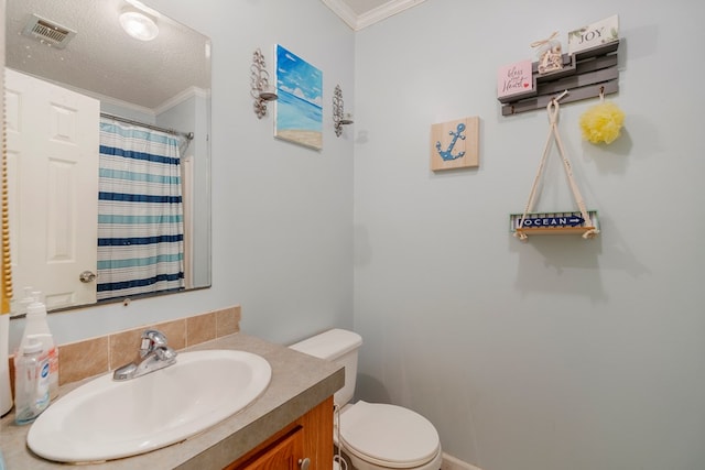 bathroom featuring curtained shower, a textured ceiling, toilet, vanity, and ornamental molding