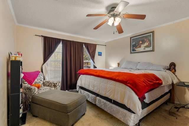 carpeted bedroom with a textured ceiling, ceiling fan, and crown molding