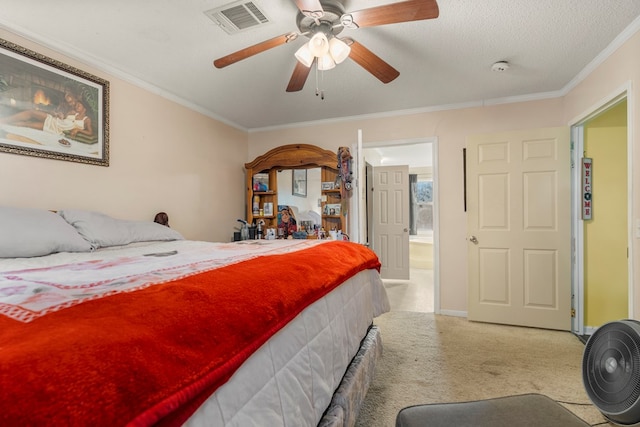 bedroom with ceiling fan, crown molding, light colored carpet, and a textured ceiling