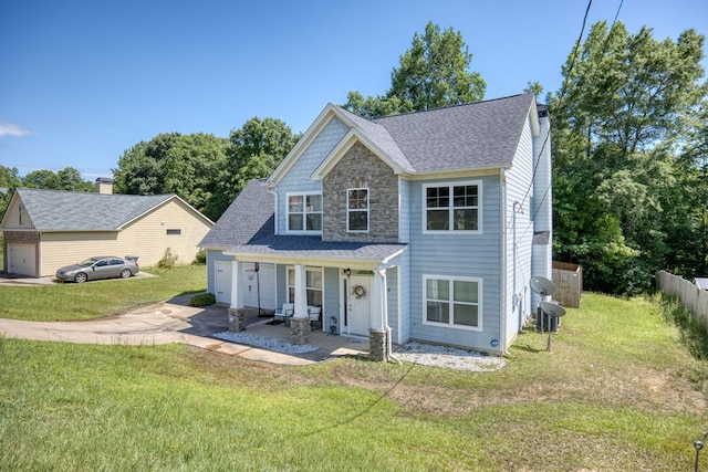 59 Misty Forest Dr, Phenix City, AL 36869 - view of front of property featuring driveway, an attached garage, a porch, stone siding, and central AC