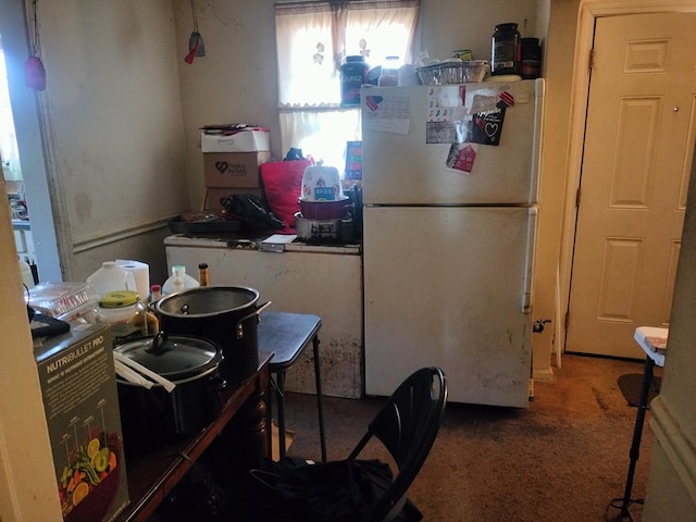 kitchen featuring white refrigerator and dark colored carpet