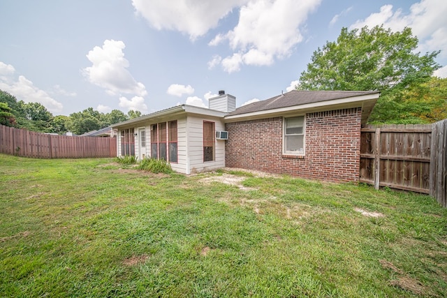 4021 Shade Valley Dr, Columbus, GA 31909 - back of house with a fenced backyard, a chimney, brick siding, and a wall mounted AC