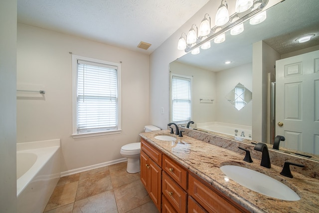 4021 Shade Valley Dr, Columbus, GA 31909 - full bathroom featuring a garden tub, double vanity, and a textured ceiling