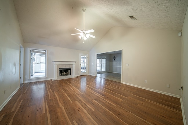 4021 Shade Valley Dr, Columbus, GA 31909 - unfurnished living room with ceiling fan, wood finished floors, a tiled fireplace, high vaulted ceiling, and a textured ceiling