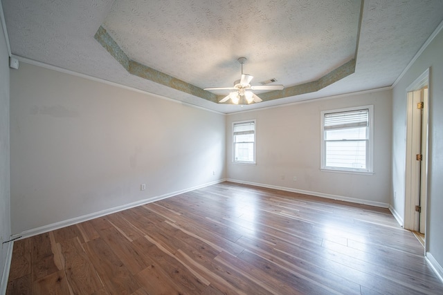 4021 Shade Valley Dr, Columbus, GA 31909 - spare room with a textured ceiling, a raised ceiling, ceiling fan, wood finished floors, and crown molding
