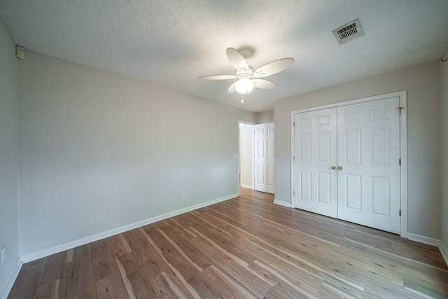 4021 Shade Valley Dr, Columbus, GA 31909 - unfurnished bedroom with a closet, wood finished floors, a ceiling fan, and a textured ceiling