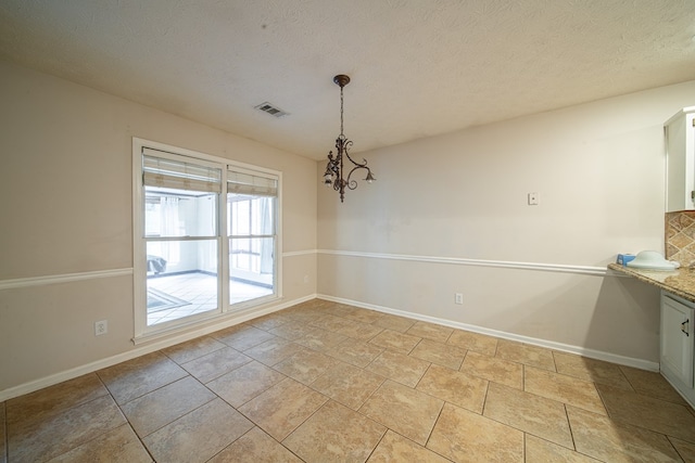 4021 Shade Valley Dr, Columbus, GA 31909 - unfurnished dining area with a chandelier and a textured ceiling