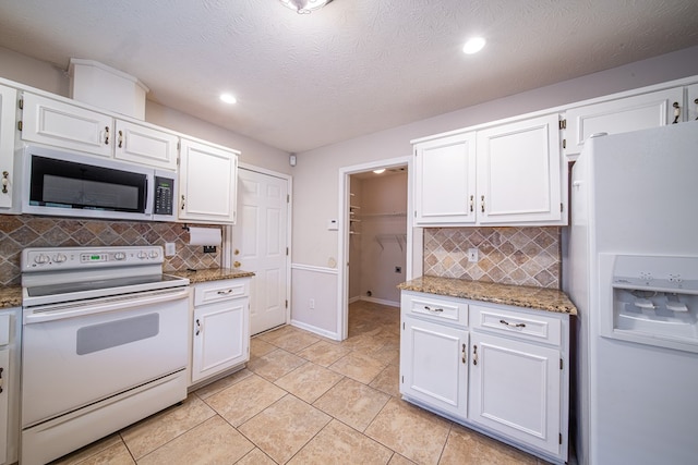4021 Shade Valley Dr, Columbus, GA 31909 - kitchen with white appliances, backsplash, white cabinets, recessed lighting, and a textured ceiling