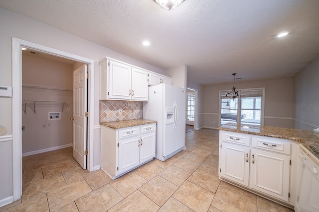 4021 Shade Valley Dr, Columbus, GA 31909 - kitchen with white appliances, tasteful backsplash, white cabinets, a chandelier, and light stone counters