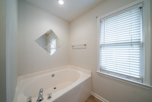4021 Shade Valley Dr, Columbus, GA 31909 - full bathroom featuring a garden tub and a textured ceiling