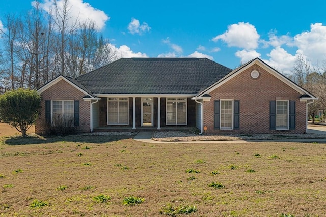 ranch-style home with a front yard and brick siding