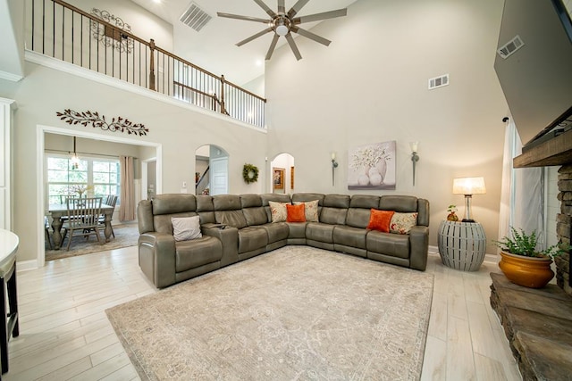 82 Rolling Meadows Way, Waverly Hall, GA 31831 - living room featuring ceiling fan, arched walkways, a high ceiling, and light wood-type flooring