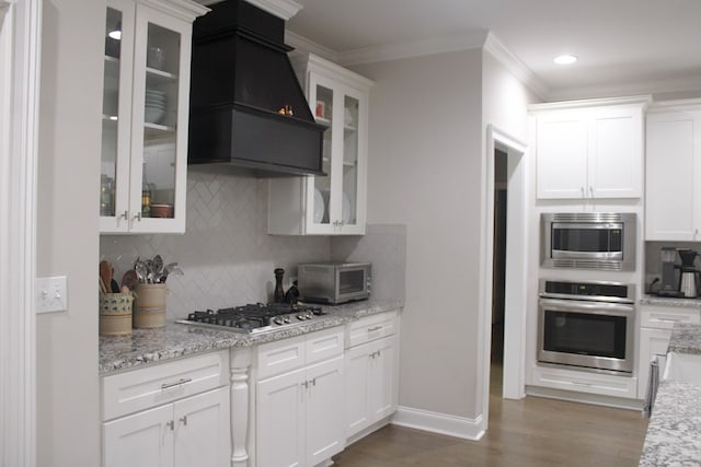406 Lakeview Way, Lagrange, GA 30240 - kitchen featuring appliances with stainless steel finishes, premium range hood, white cabinets, baseboards, and crown molding