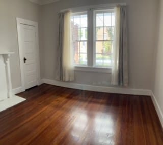 unfurnished room featuring dark hardwood / wood-style floors