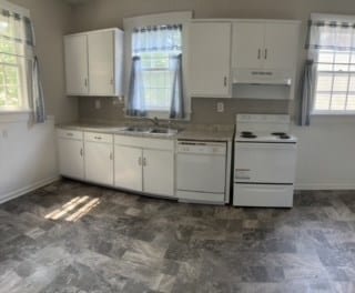 kitchen featuring white cabinets, a healthy amount of sunlight, white appliances, and sink