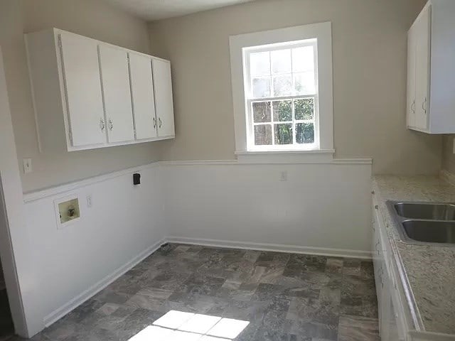 clothes washing area featuring cabinets, washer hookup, hookup for an electric dryer, and sink