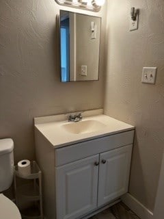 bathroom featuring vanity and toilet