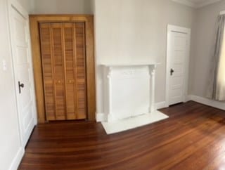 interior space featuring crown molding and dark wood-type flooring