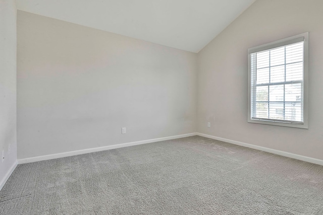 unfurnished room with carpet and lofted ceiling