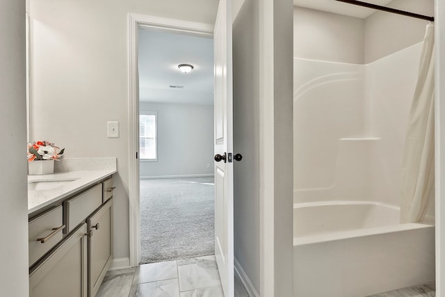 bathroom featuring shower / bath combo with shower curtain and vanity