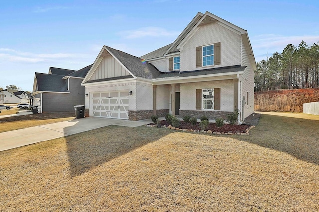 craftsman house with a front yard and a garage