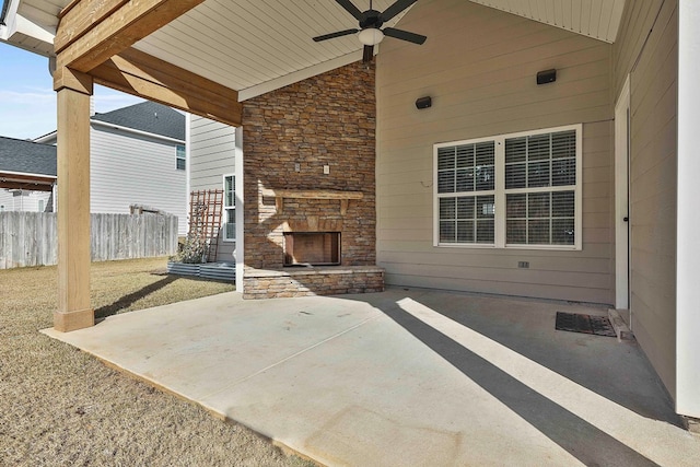 view of patio / terrace with an outdoor stone fireplace and ceiling fan