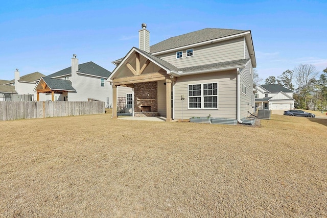 rear view of property featuring a fireplace and cooling unit