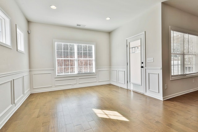 foyer with hardwood / wood-style flooring and a wealth of natural light