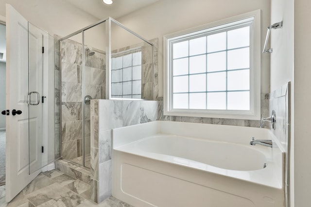 bathroom featuring independent shower and bath