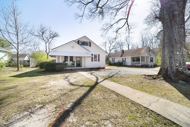 2418 34th St, Valley, AL 36854 - bungalow with covered porch, fence, and a front lawn