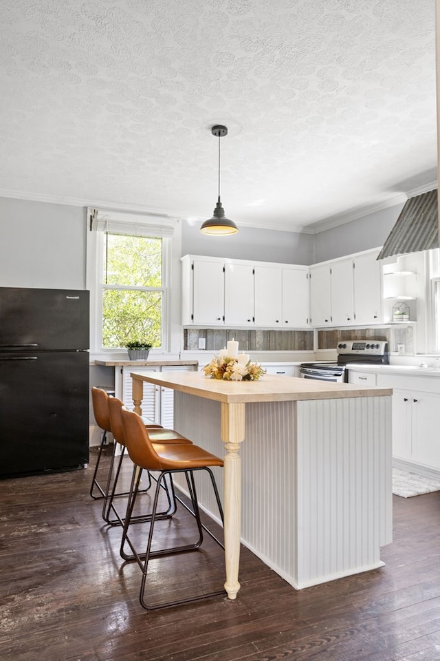 2418 34th St, Valley, AL 36854 - kitchen featuring stainless steel electric range, freestanding refrigerator, light countertops, and dark wood finished floors