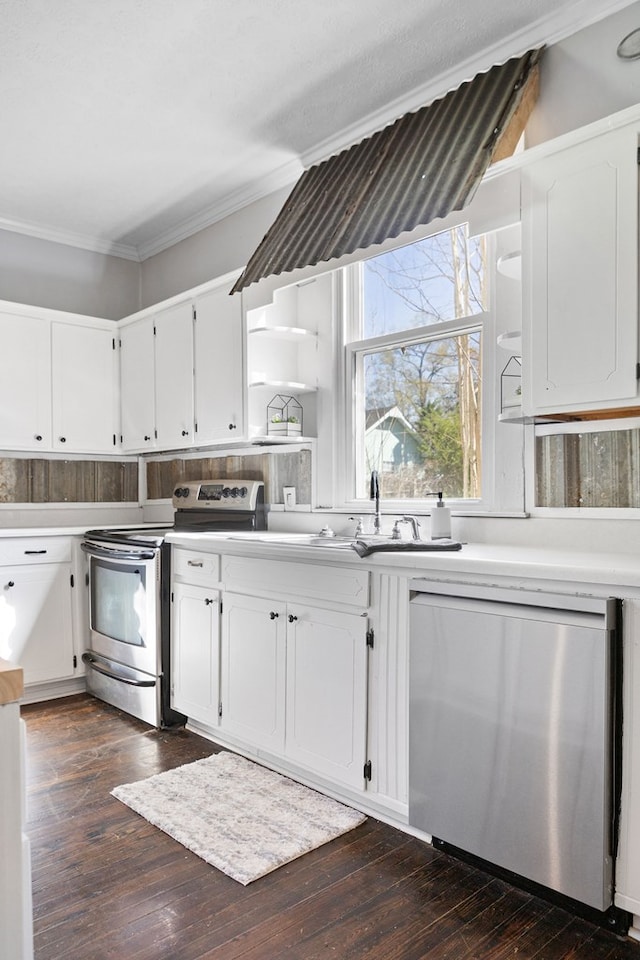 2418 34th St, Valley, AL 36854 - kitchen with dark wood-style flooring, ornamental molding, light countertops, white cabinetry, and stainless steel appliances