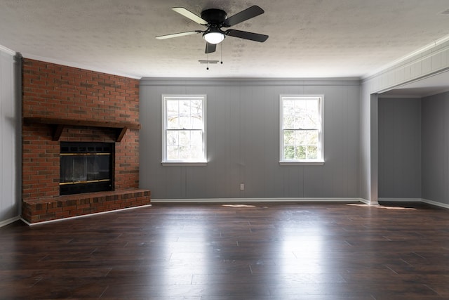 unfurnished living room featuring hardwood / wood-style flooring, plenty of natural light, a fireplace, and a textured ceiling