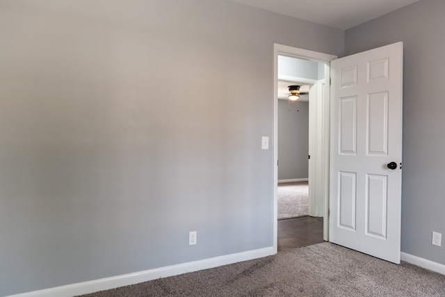 carpeted empty room with baseboards